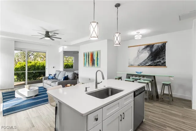a kitchen with a sink a counter top space and a chandelier