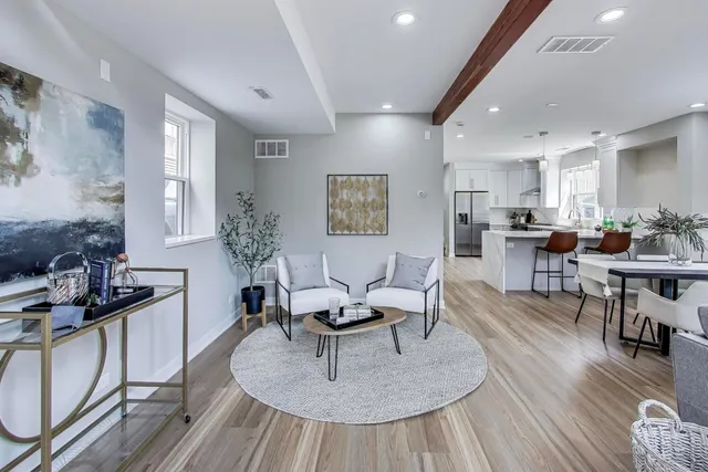 a living room with furniture and wooden floor