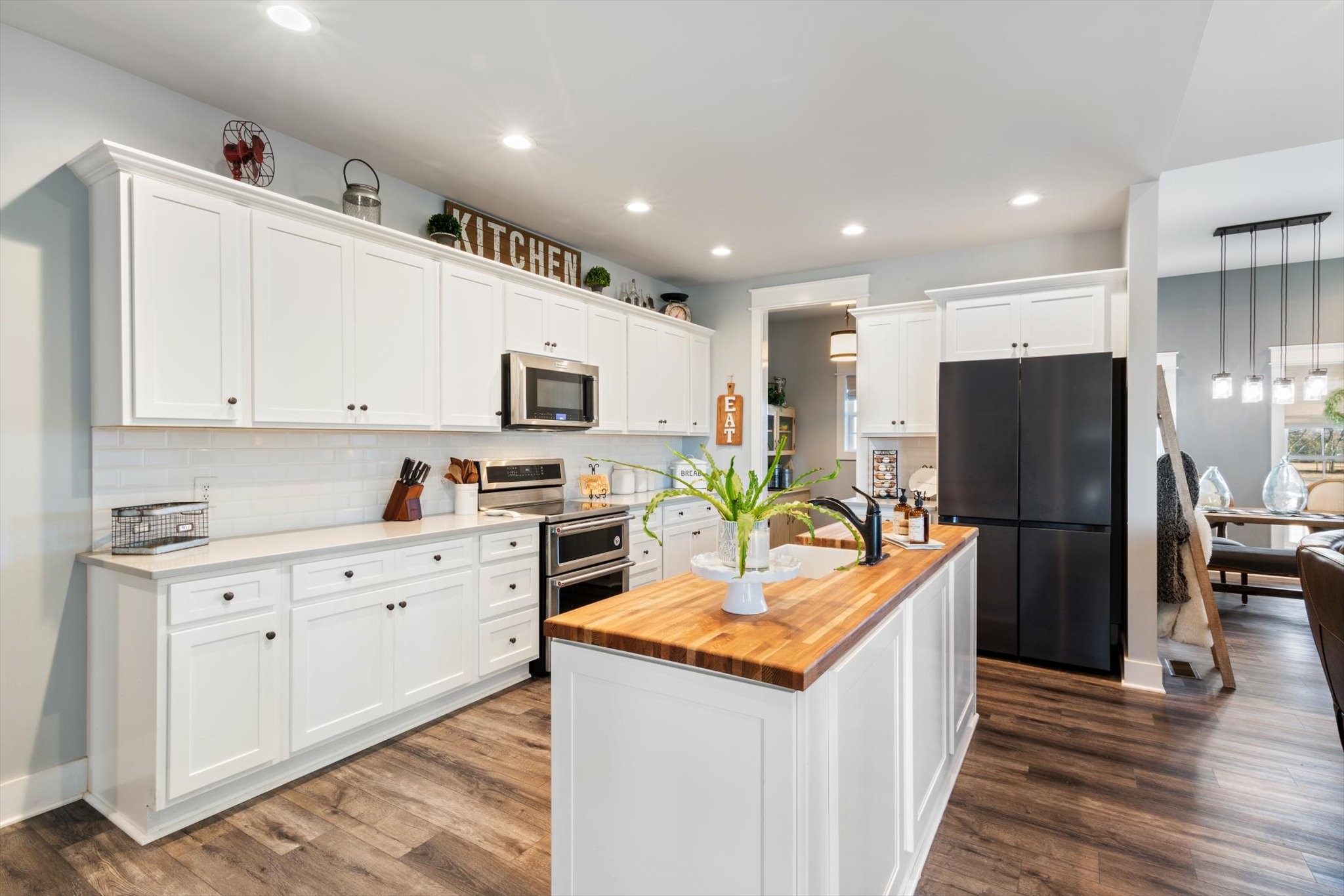 2114 Longview Road Rockvale, TN 37153 - Photo 29 of 48 a kitchen with stainless steel appliances granite countertop a refrigerator a stove top oven a sink dishwasher and wooden cabinets with wooden floor
