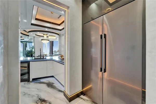 a living room with stainless steel appliances kitchen island granite countertop furniture and a large window