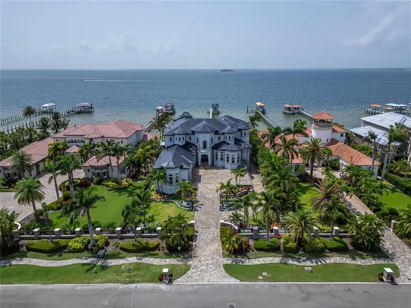 an aerial view of a house with a yard swimming pool and outdoor seating