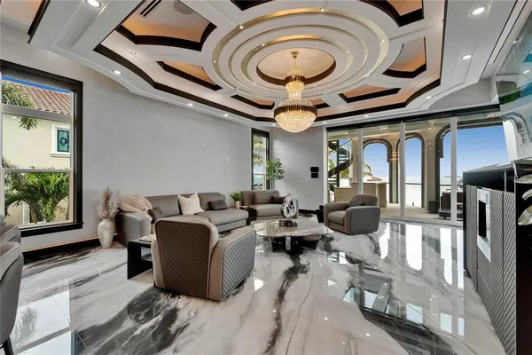 a living room with furniture and a floor to ceiling window