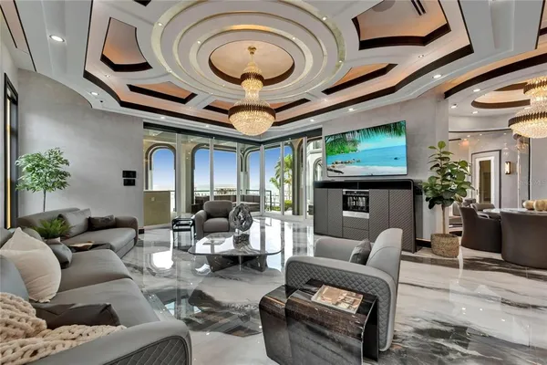a bedroom with a large bed and a chandelier