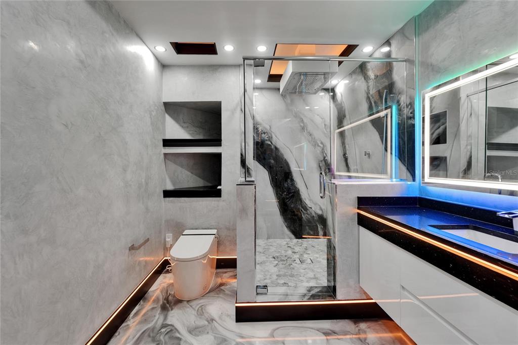 6526 Surfside Boulevard Apollo Beach, FL 33572 - Photo 96 of 99 a bathroom with a sink a toilet and a mirror