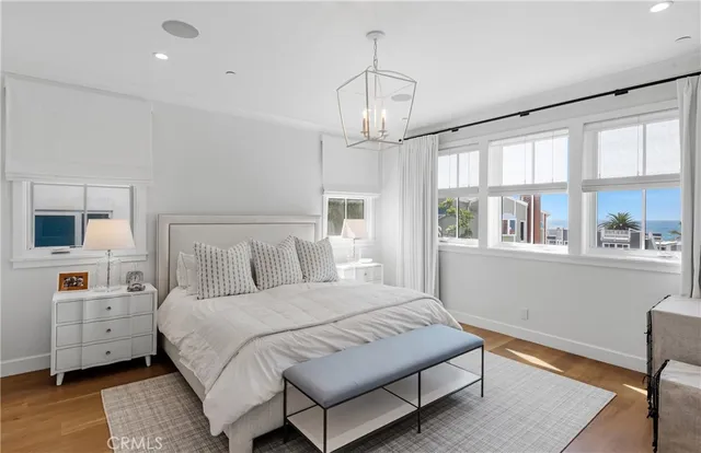 a bedroom with a large bed and a chandelier