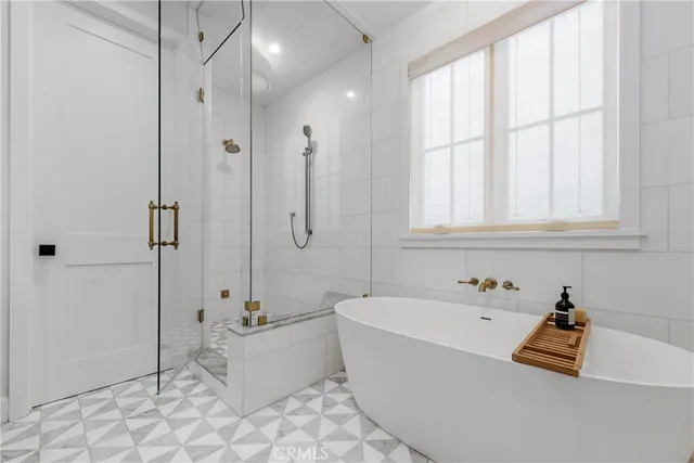 a bathroom with bathtub and shower