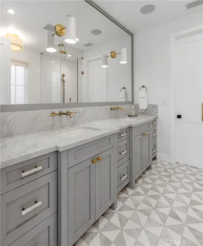 a bathroom with a sink vanity and mirror