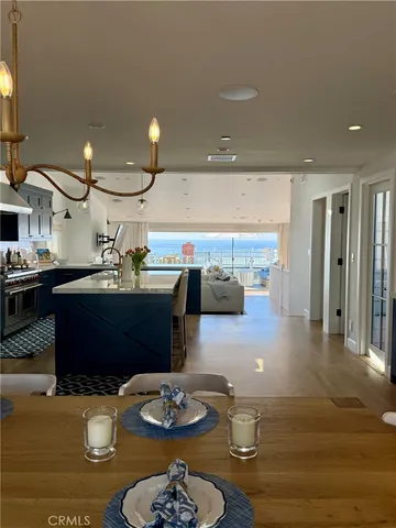 a dining room with wooden floor a glass table and chairs