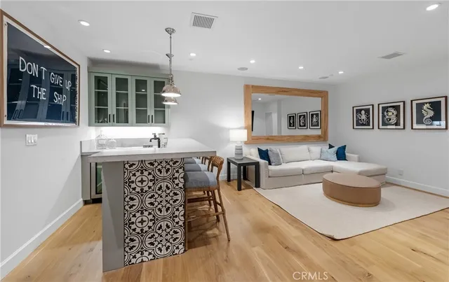 a living room with furniture a window and a painting on the wall