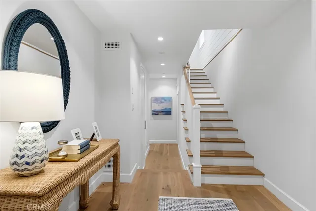 a view of entryway and hall with wooden floor