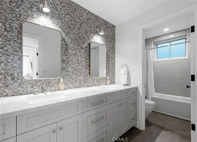 a bathroom with 2 sink tub and a mirror