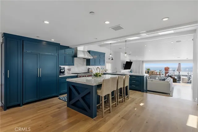 a large kitchen with kitchen island a sink a center island stainless steel appliances and a center island