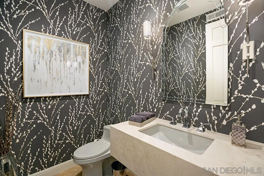 14150 Steeple Chase Row San Diego, CA 92130 - Photo 13 of 25 a bathroom with a toilet sink and mirror