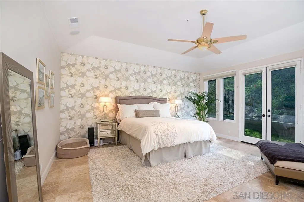 14150 Steeple Chase Row San Diego, CA 92130 - Photo 18 of 25 a bed room with a bed and a couch