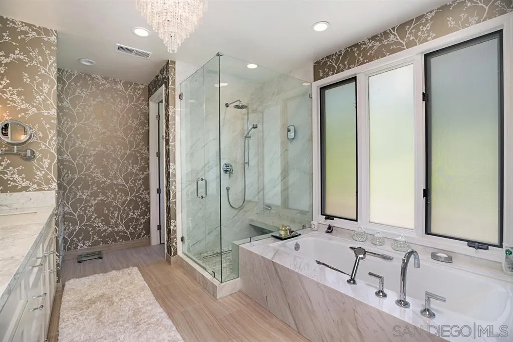 14150 Steeple Chase Row San Diego, CA 92130 - Photo 19 of 25 a spacious bathroom with a double vanity sink mirror and shower