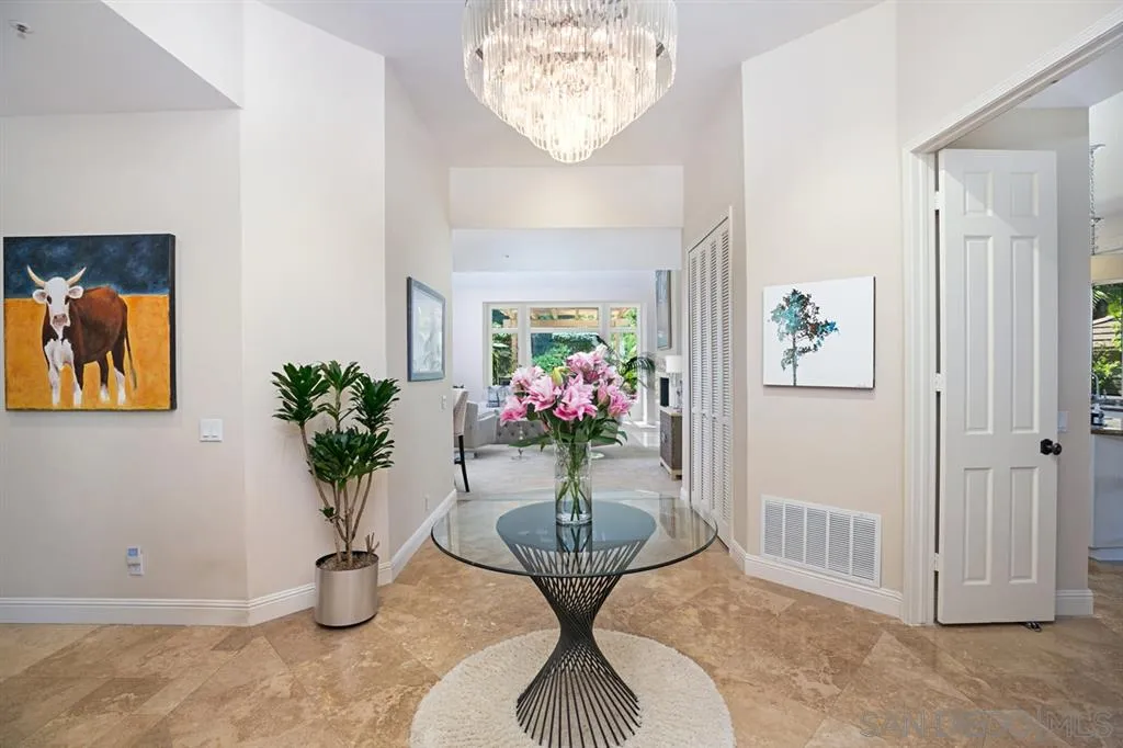 14150 Steeple Chase Row San Diego, CA 92130 - Photo 2 of 25 a vase of flowers sitting on a table with a potted plant