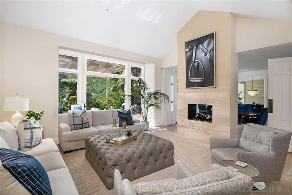 14150 Steeple Chase Row San Diego, CA 92130 - Photo 3 of 25 a living room with furniture fireplace and a large window