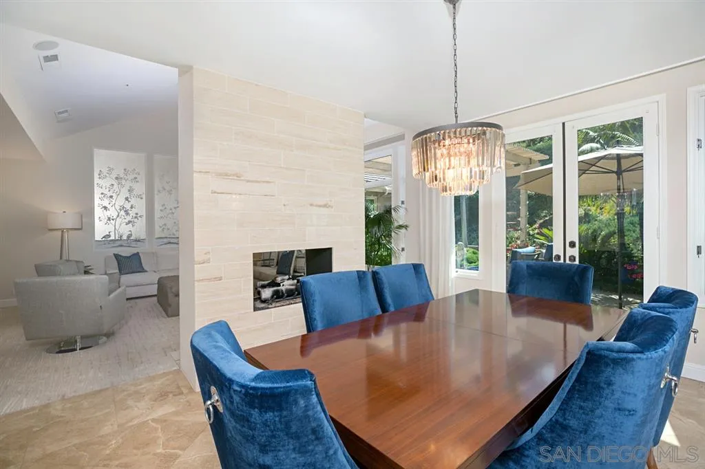 14150 Steeple Chase Row San Diego, CA 92130 - Photo 6 of 25 a living room with furniture chandelier and a fireplace