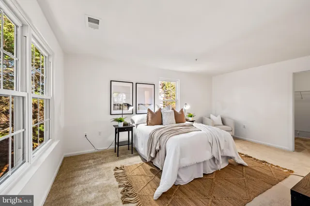 a bed room with a bed and a large window