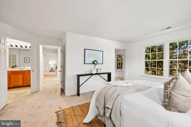 a bedroom with a bed and a large mirror