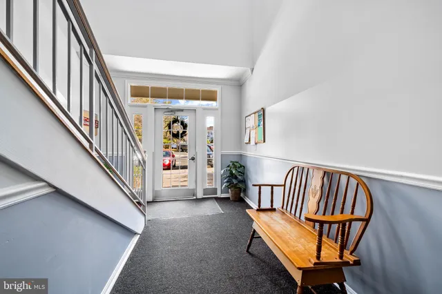 a view of staircase with furniture and a window