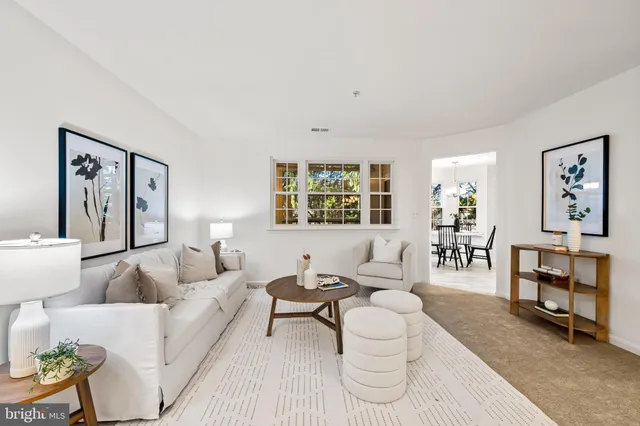 a living room with furniture and painting on the wall