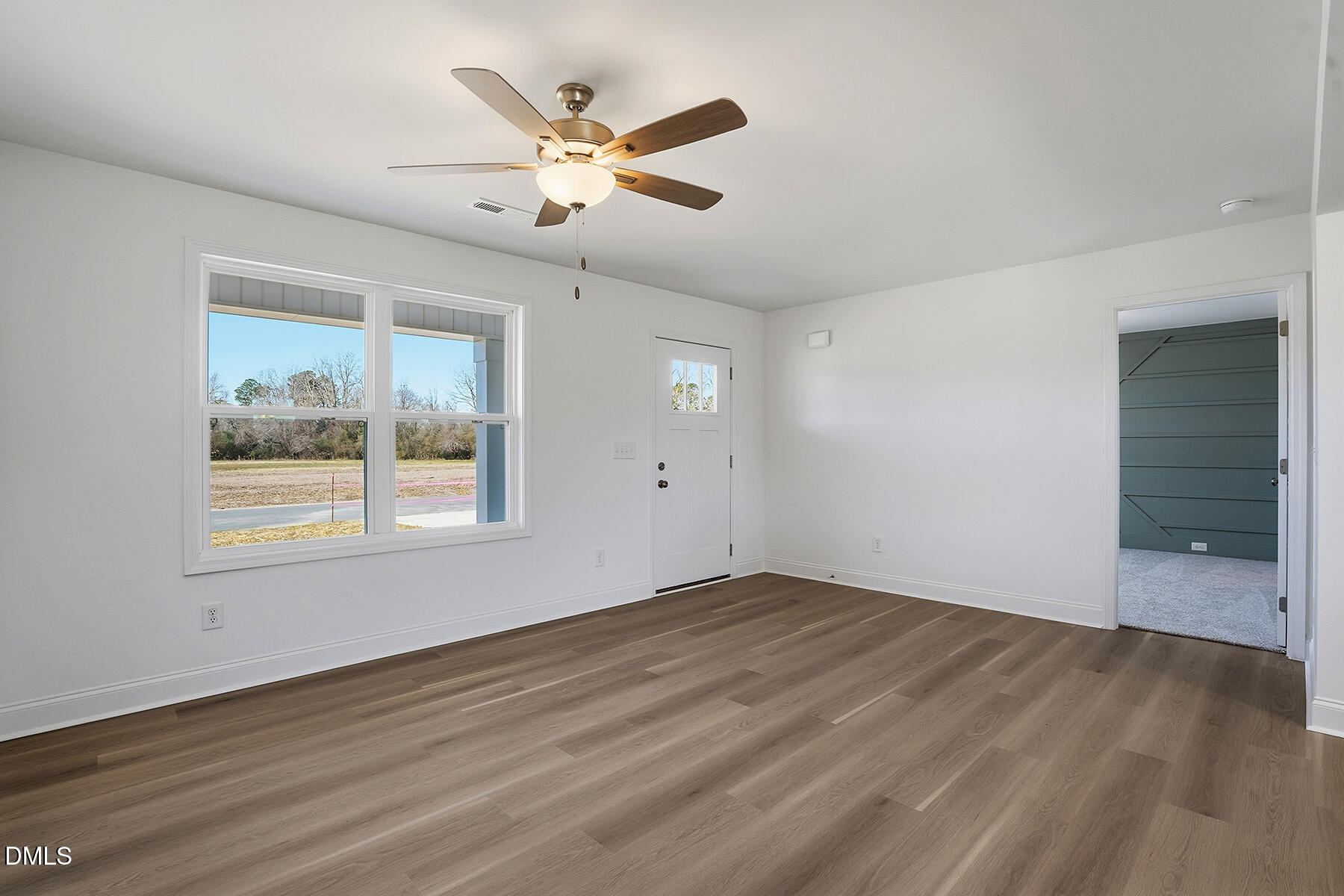 236 Rae Street Warsaw, NC 28398 - Photo 7 of 29 a view of an empty room with wooden floor and a window