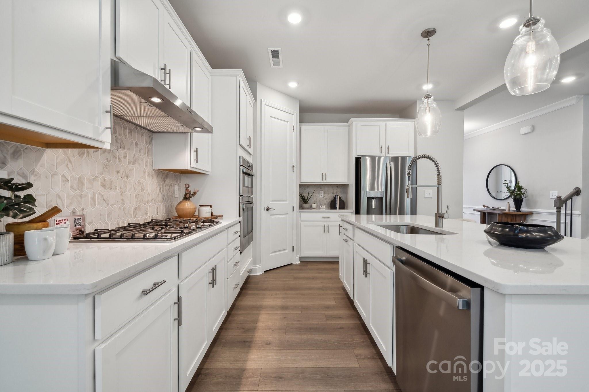5088 Duval Circle Tega Cay, SC 29708 - Photo 12 of 41 a kitchen with stainless steel appliances a sink stove and cabinets