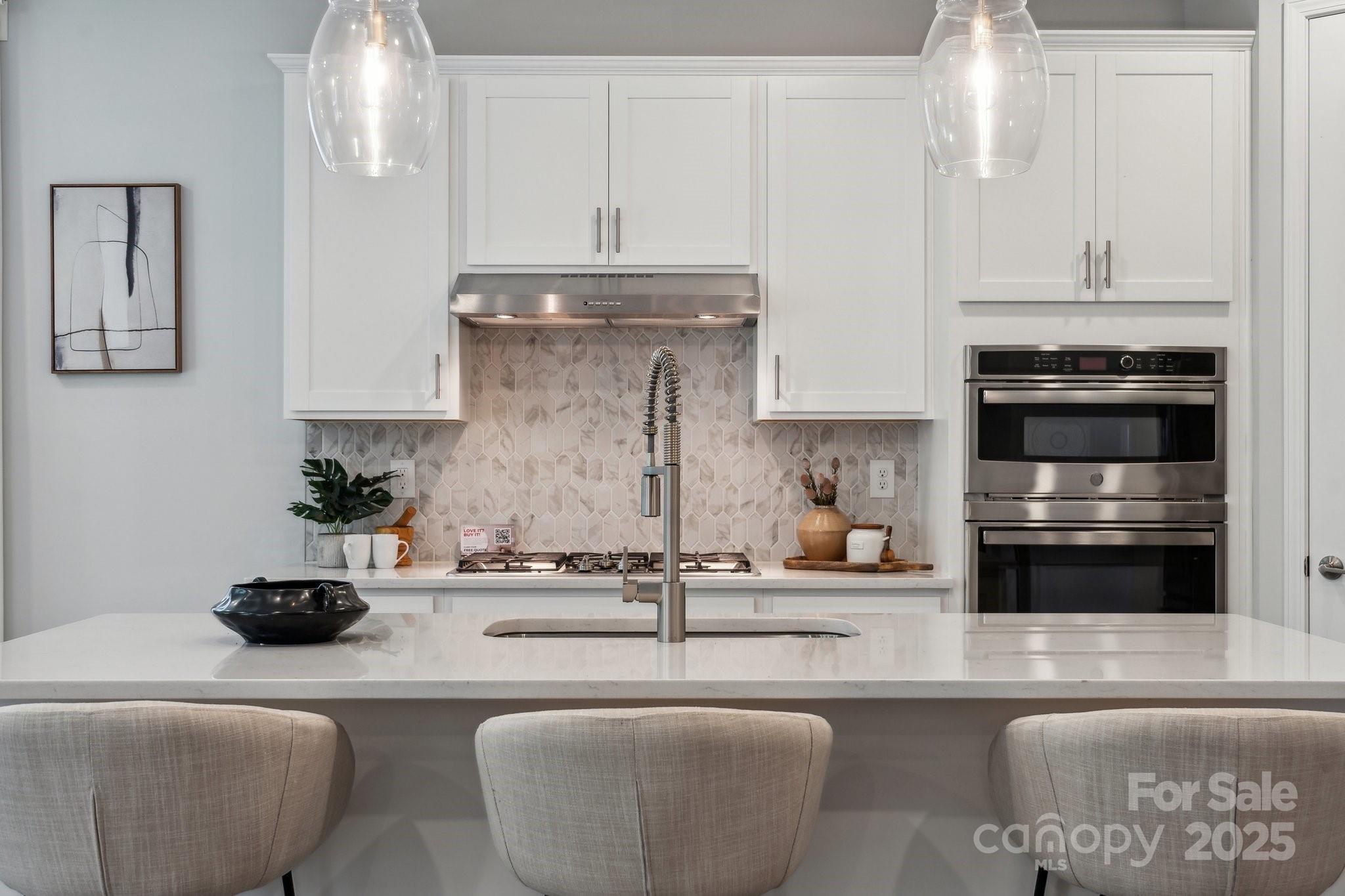 5088 Duval Circle Tega Cay, SC 29708 - Photo 14 of 41 a kitchen with a stove and a white cabinets