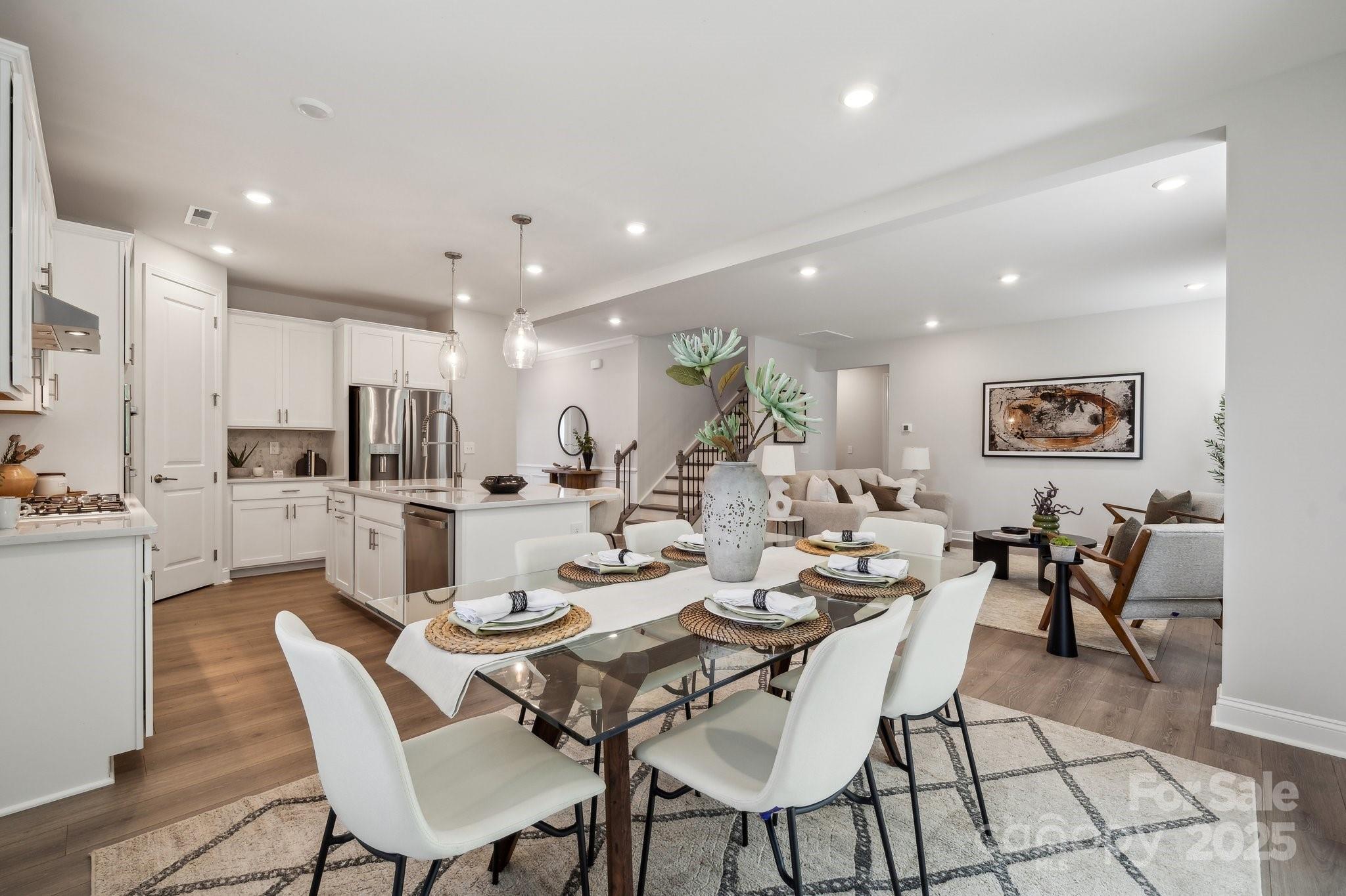 5088 Duval Circle Tega Cay, SC 29708 - Photo 16 of 41 a dining room with stainless steel appliances kitchen island a table and chairs