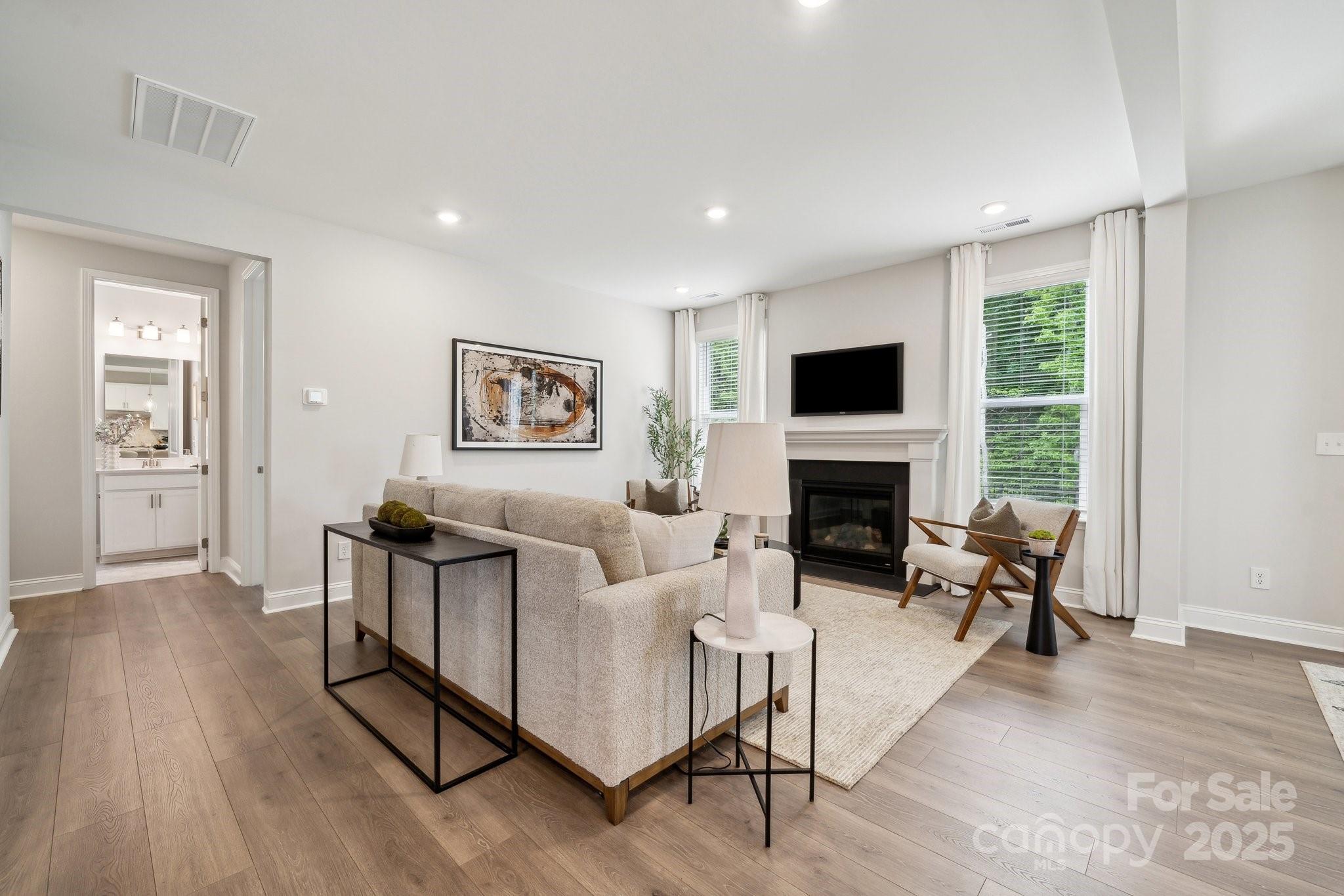 5088 Duval Circle Tega Cay, SC 29708 - Photo 18 of 41 a living room with furniture a fireplace and a flat screen tv