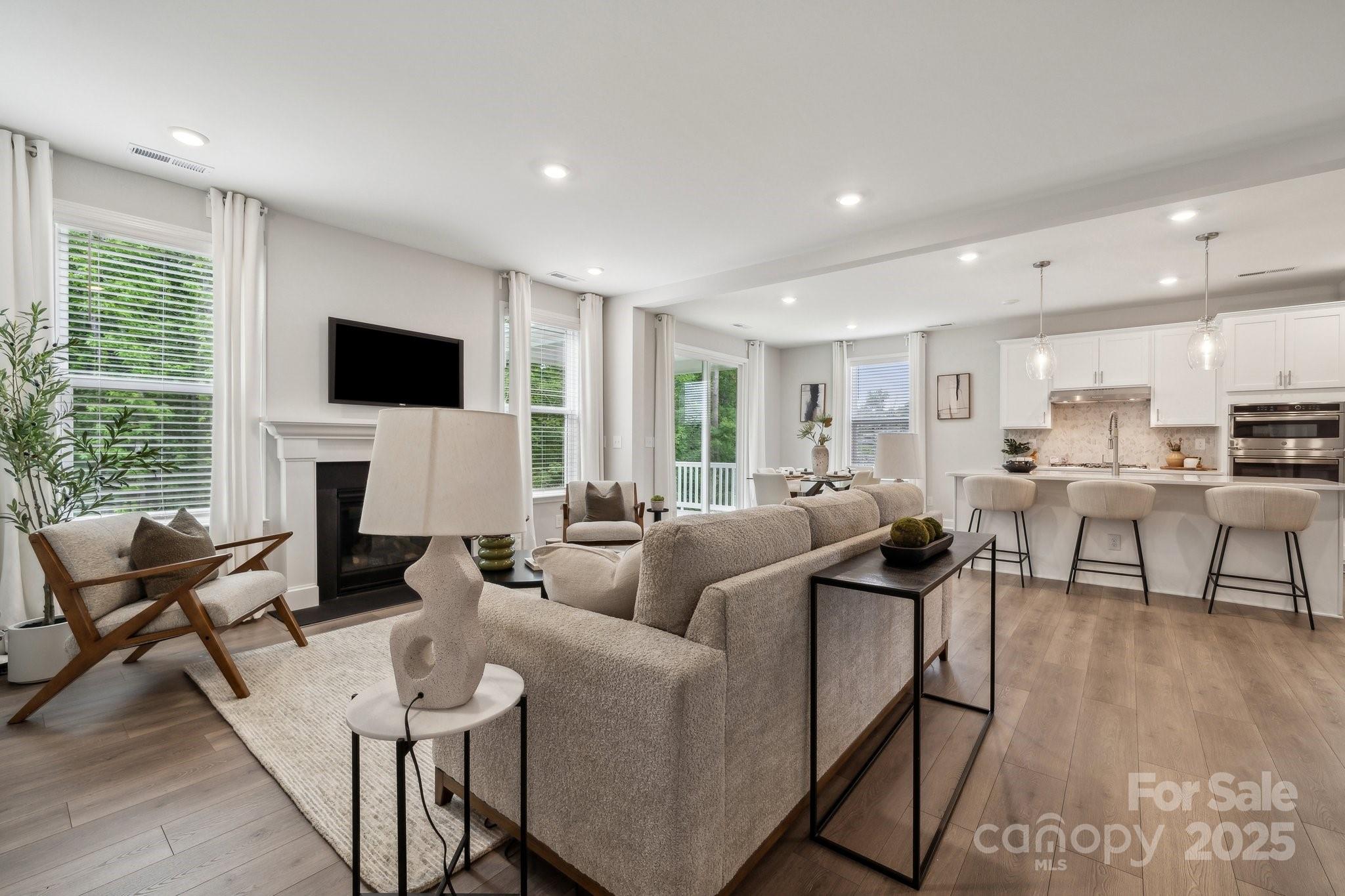 5088 Duval Circle Tega Cay, SC 29708 - Photo 24 of 41 a living room with furniture a fireplace and a flat screen tv