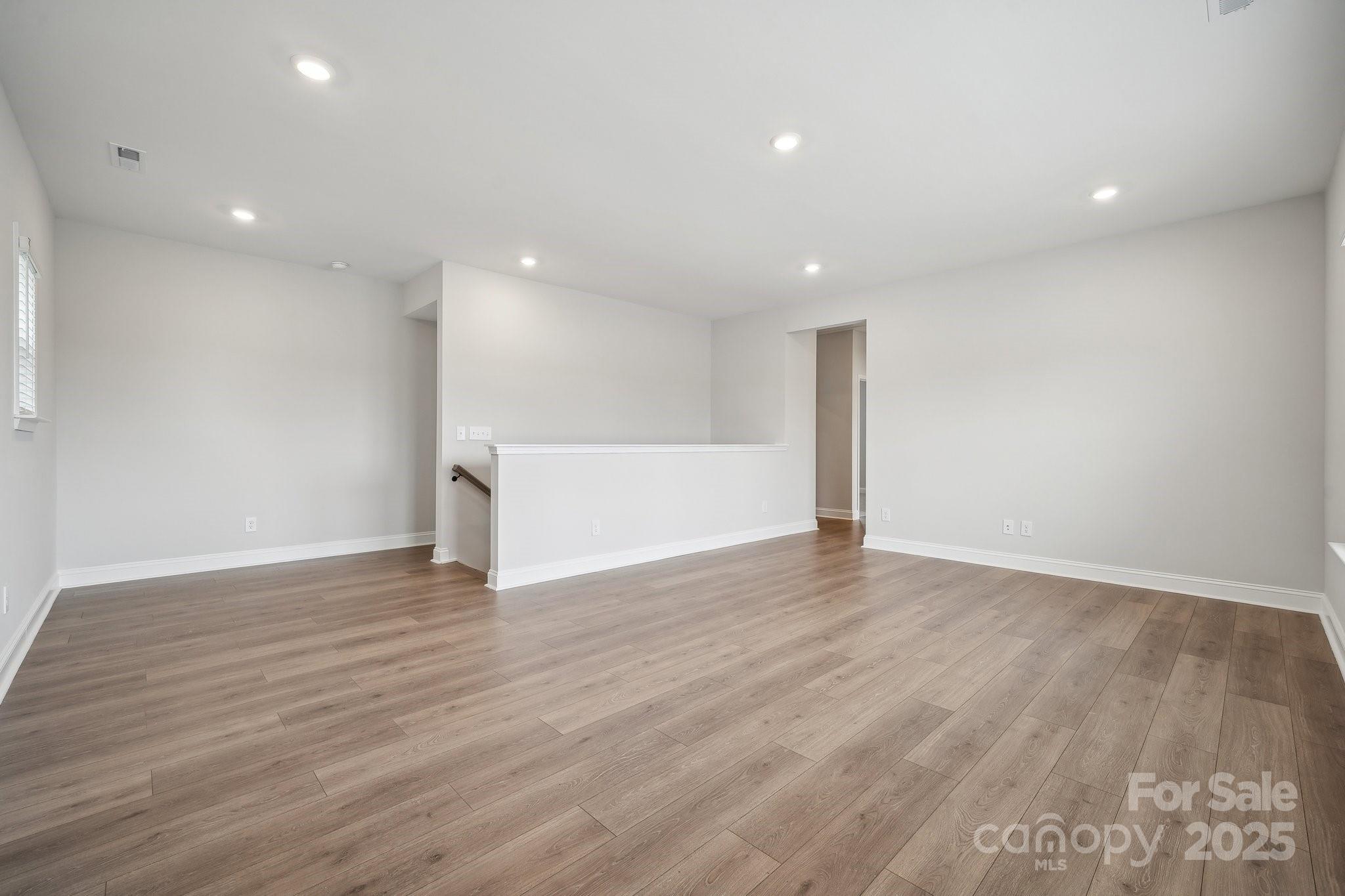 5088 Duval Circle Tega Cay, SC 29708 - Photo 25 of 41 a view of an empty room with wooden floor