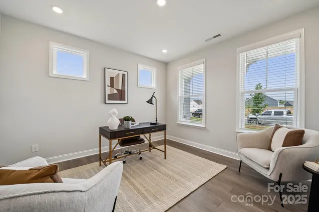 a kitchen with stainless steel appliances a table chairs refrigerator and microwave