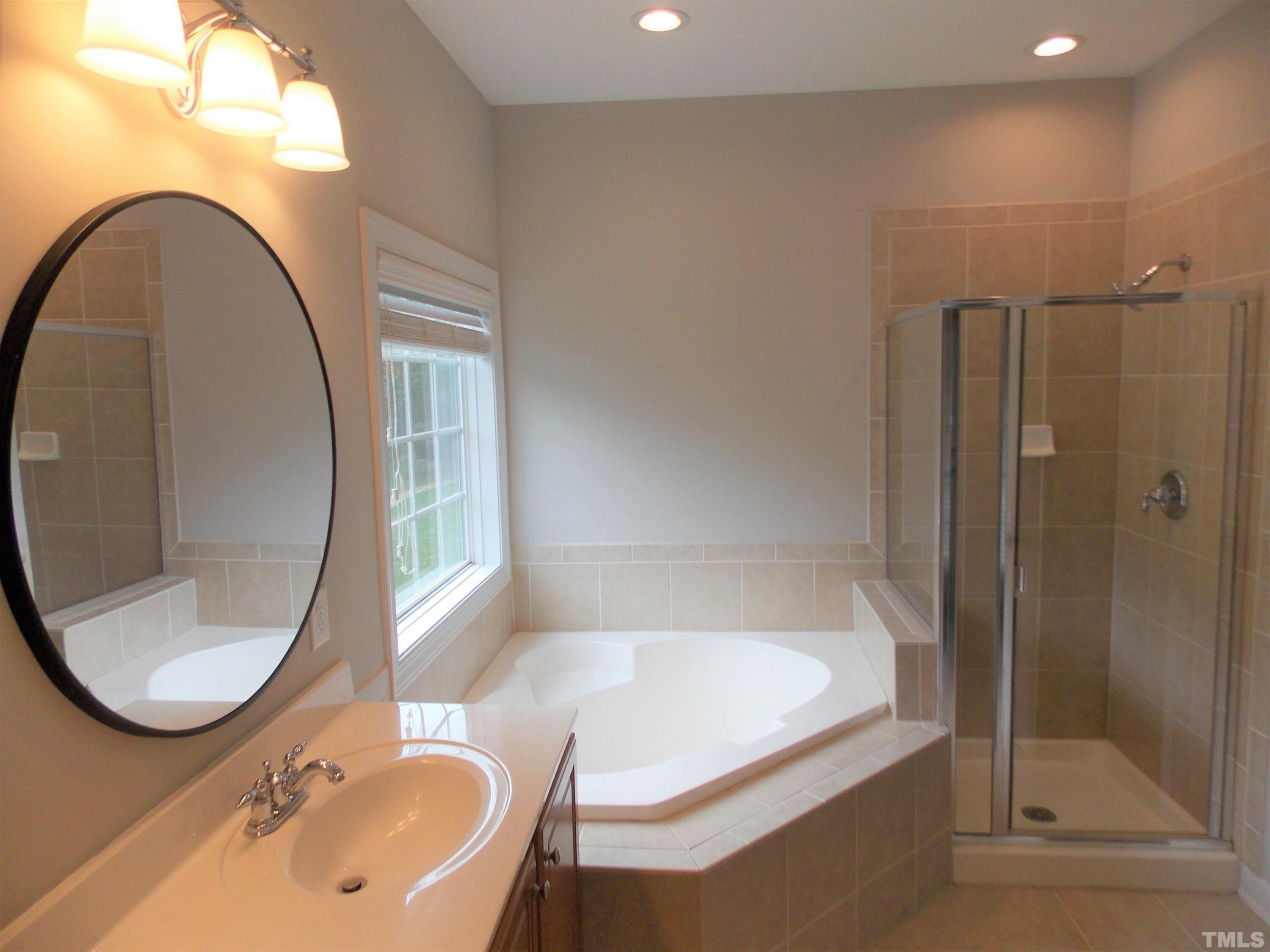 4032 Abbey Park Way Raleigh, NC 27612 - Photo 14 of 35 a bathroom with a sink and a mirror