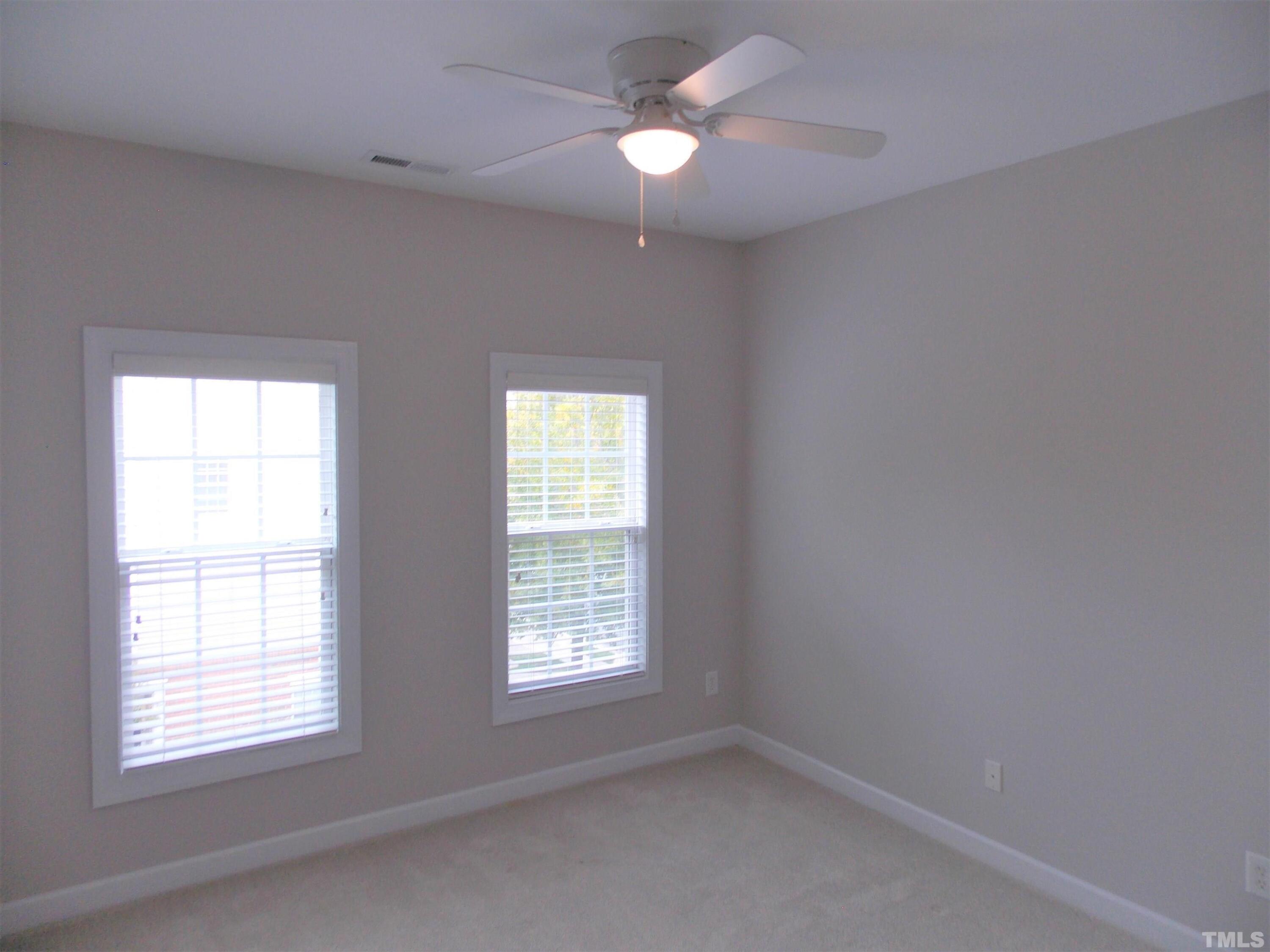 4032 Abbey Park Way Raleigh, NC 27612 - Photo 18 of 35 an empty room with a window and a fan