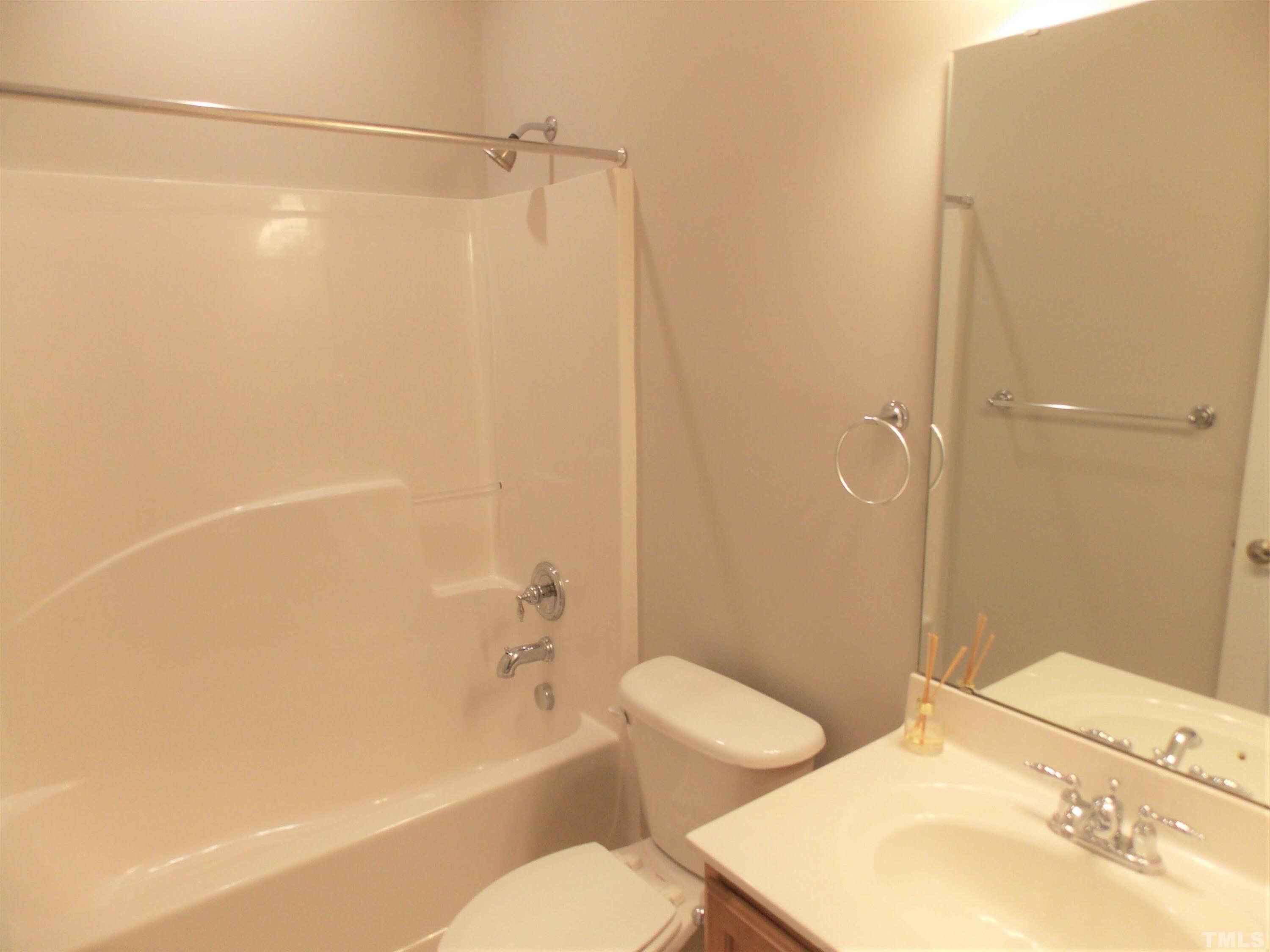 4032 Abbey Park Way Raleigh, NC 27612 - Photo 20 of 35 a bathroom with a bathtub shower sink vanity and toilet