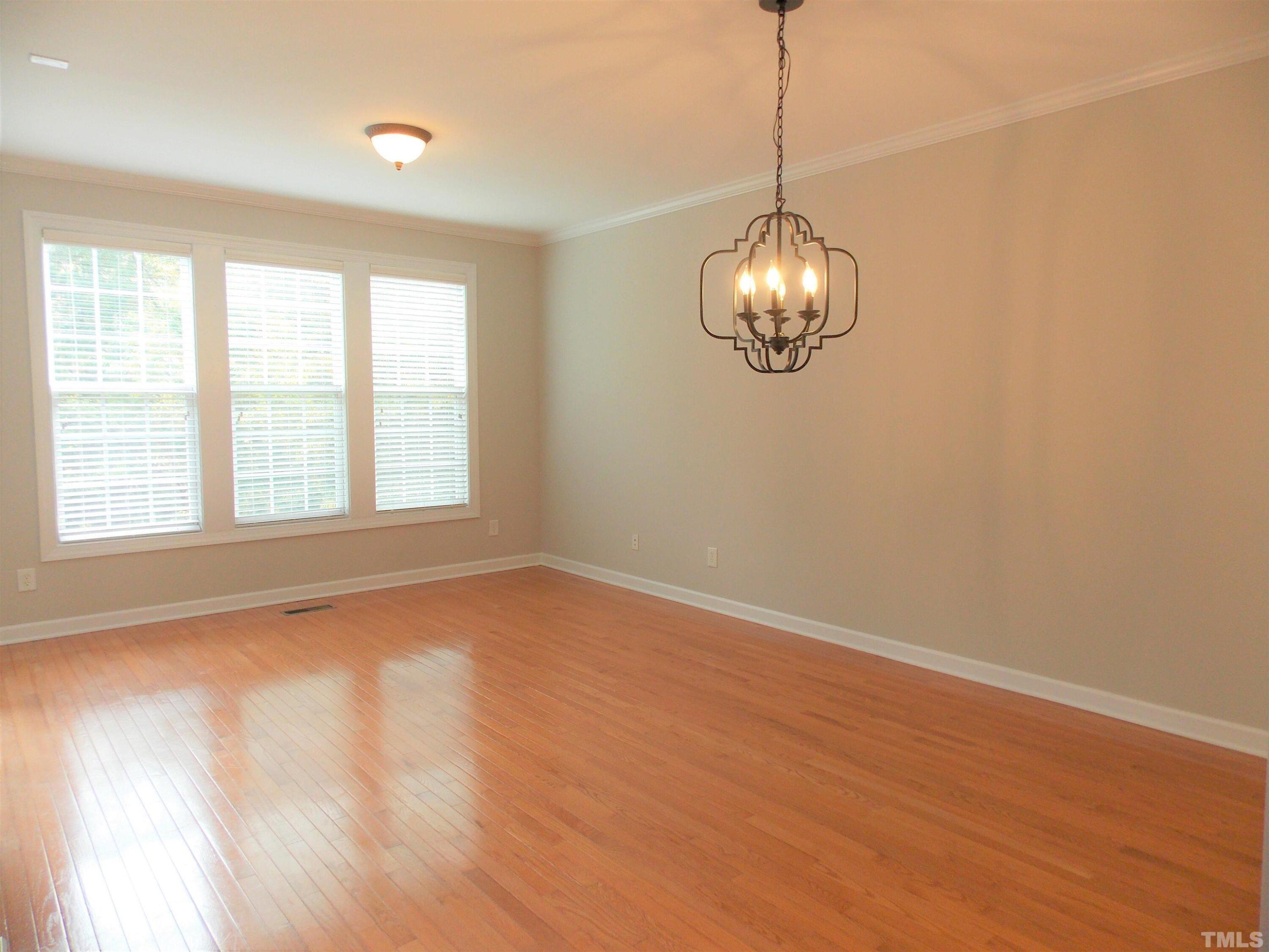 4032 Abbey Park Way Raleigh, NC 27612 - Photo 8 of 35 a view of empty room with wooden floor and fan