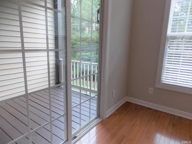 a view of wooden floor and windows in a room