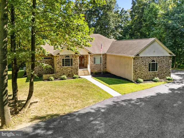 a view of a house with swimming pool and sitting area