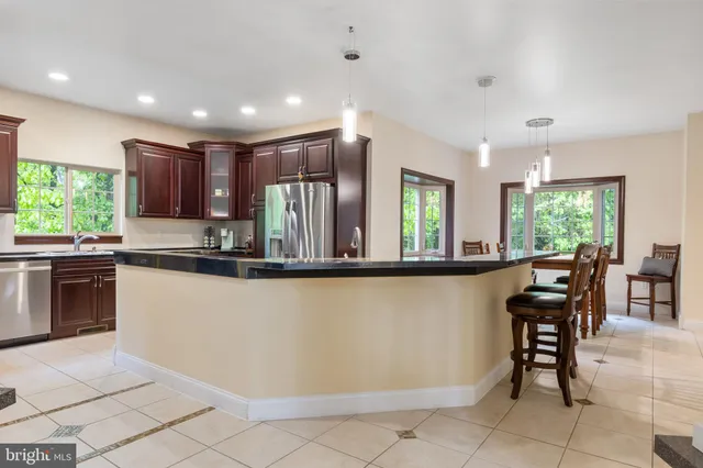 a bedroom with a bed chair and the view of a window
