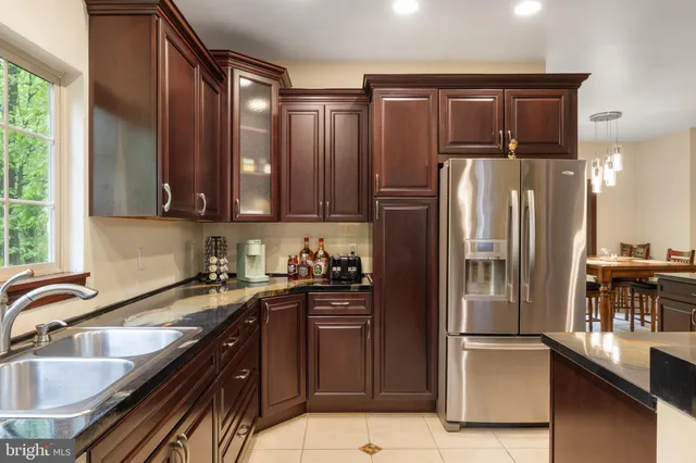 a bathroom with a sink a toilet a mirror and shower