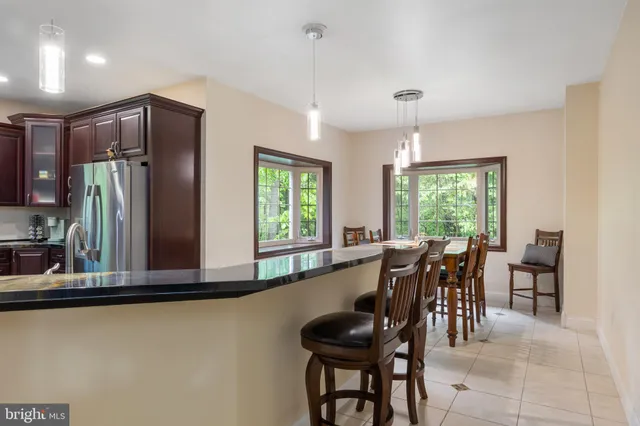 a room with a sink cabinets and a mirror