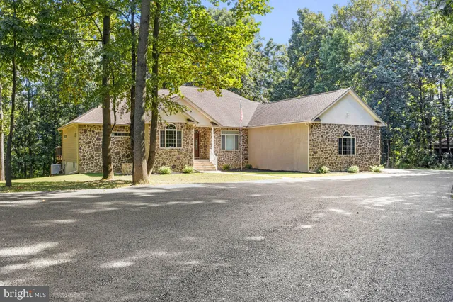 a view of a house with a yard and sitting area