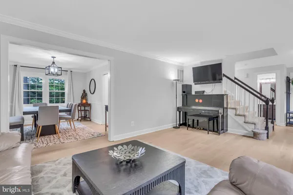 a living room with furniture a fireplace and a large window