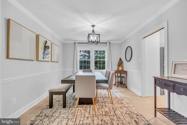 a living room with furniture a large window and a fireplace