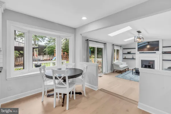 a large kitchen with kitchen island a dining table and chairs