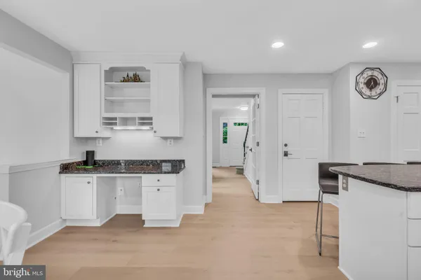 a kitchen with stainless steel appliances granite countertop a sink and a refrigerator