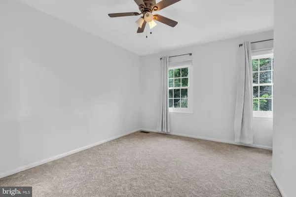 a bedroom with a bed and a lamp on the dresser