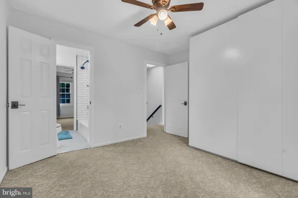 a white toilet sitting next to a window in a room